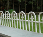 White metal garden fence with arched pickets, perfect for outdoor home decor and yard borders