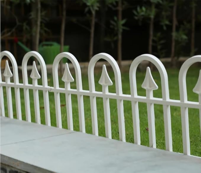 White metal garden fence with arched pickets, perfect for outdoor home decor and yard borders