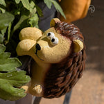 Climbing hedgehog garden ornament on plastic pot — outdoor resin pot hanger for balcony and terrace décor