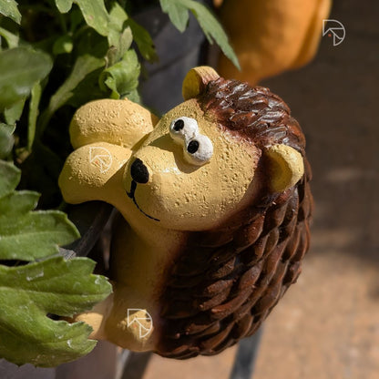 Climbing hedgehog garden ornament on plastic pot — outdoor resin pot hanger for balcony and terrace décor