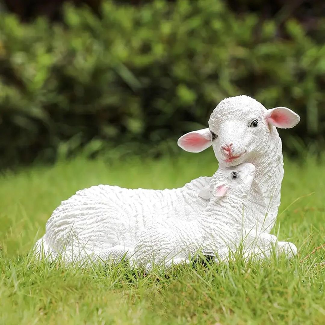 White lamb sculpture on grass with blurred green background