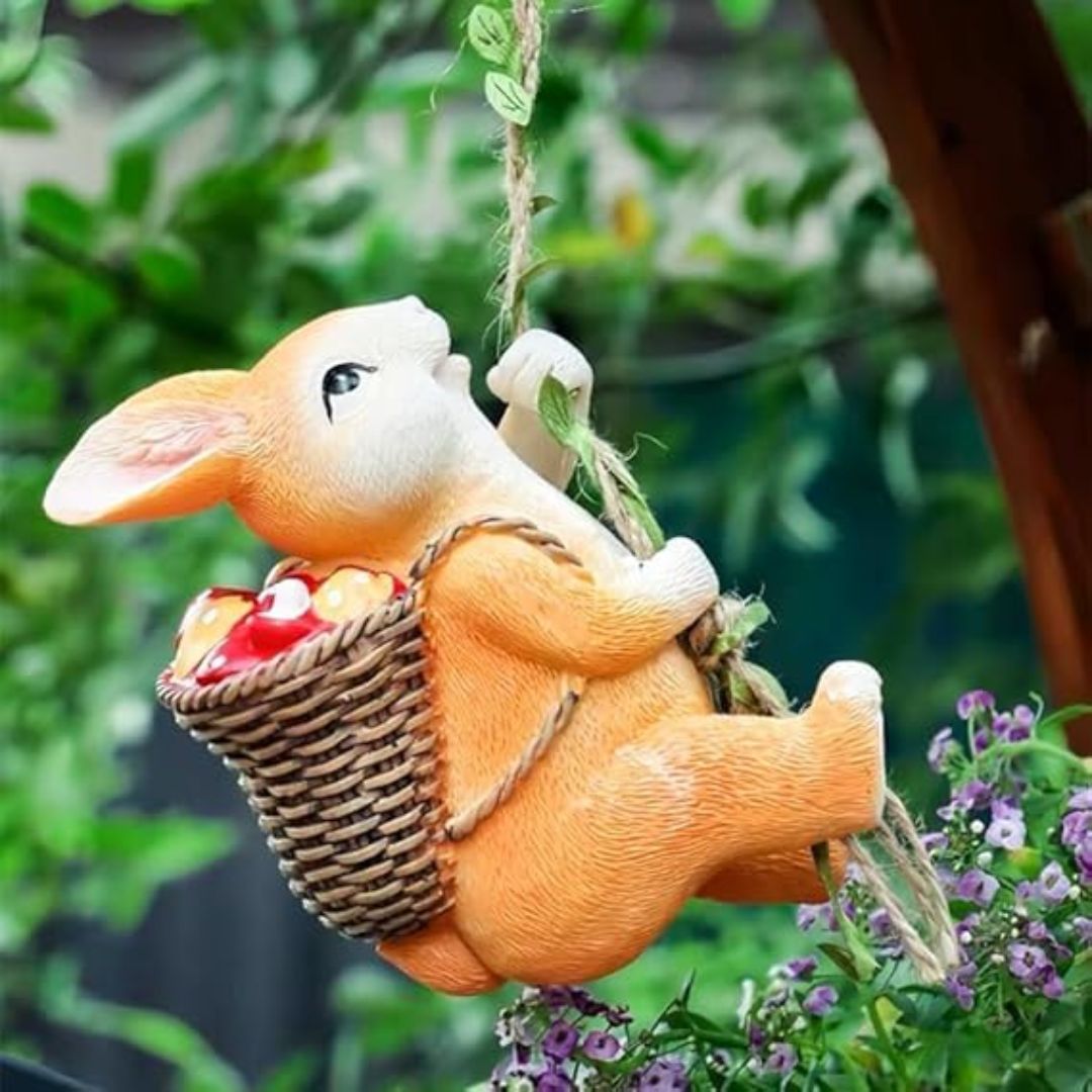 Decorative rabbit figurine holding a basket with flowers and leaves in the background