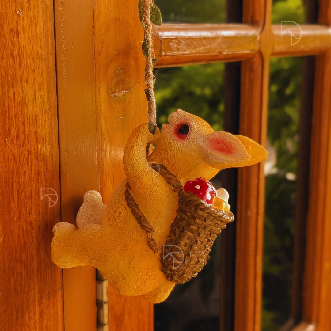 Yellow rabbit figurine with a basket hanging on a wooden door