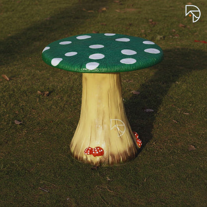 Mushroom-shaped stool with green cap and beige stem on grass