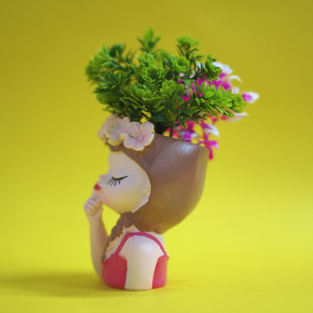 Decorative figurine of a girl with flowers in her hair on a yellow background
