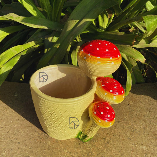 Whimsical mushroom garden pot made of durable polyresin, perfect for balcony decor, fairy garden setups, or outdoor planting. Features a drainage hole for healthy plants and vibrant color that won't fade in sunlight or rain.