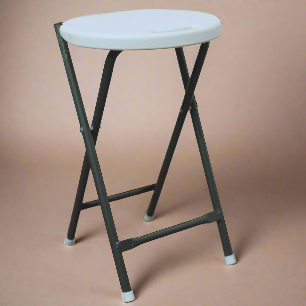 Foldable stool with white seat and black metal frame on a wooden floor.