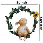 Cute rabbit figurine sitting in a green leaf wreath with a sunflower, 6-inch décor piece